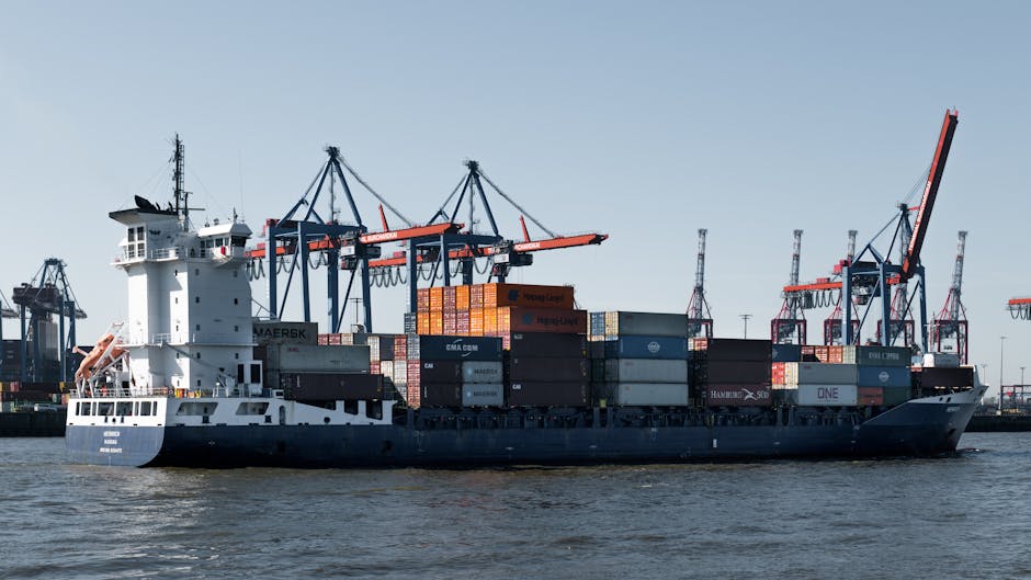 A container ship in Hamburg port with cranes loading cargo for global trade.